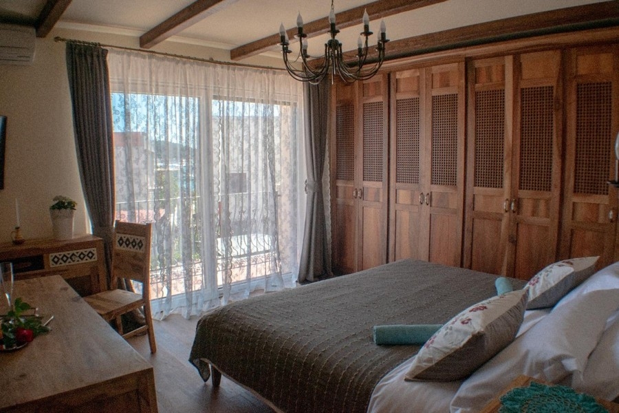 Bedroom with wooden wardrobes and terrace access