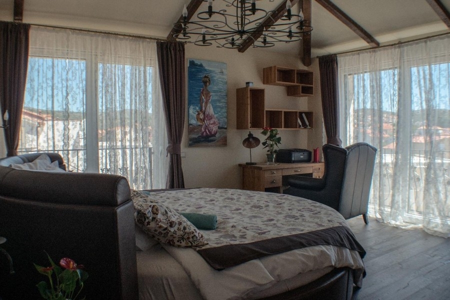 Living area with armchairs and large windows