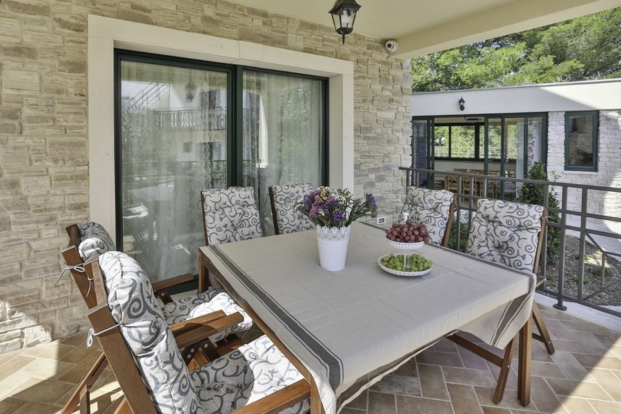 Covered terrace with seating area and table