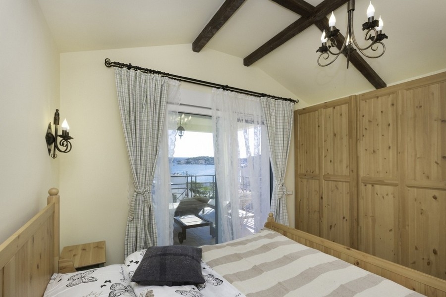 Bedroom with balcony access and wooden ceiling
