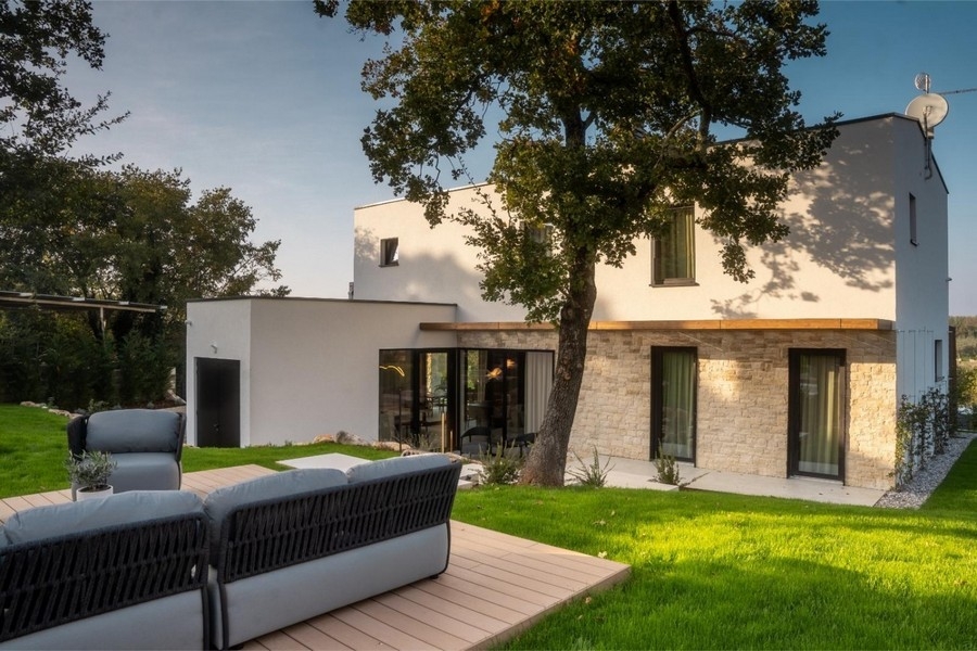Villa with stone facade and lounge on wooden deck
