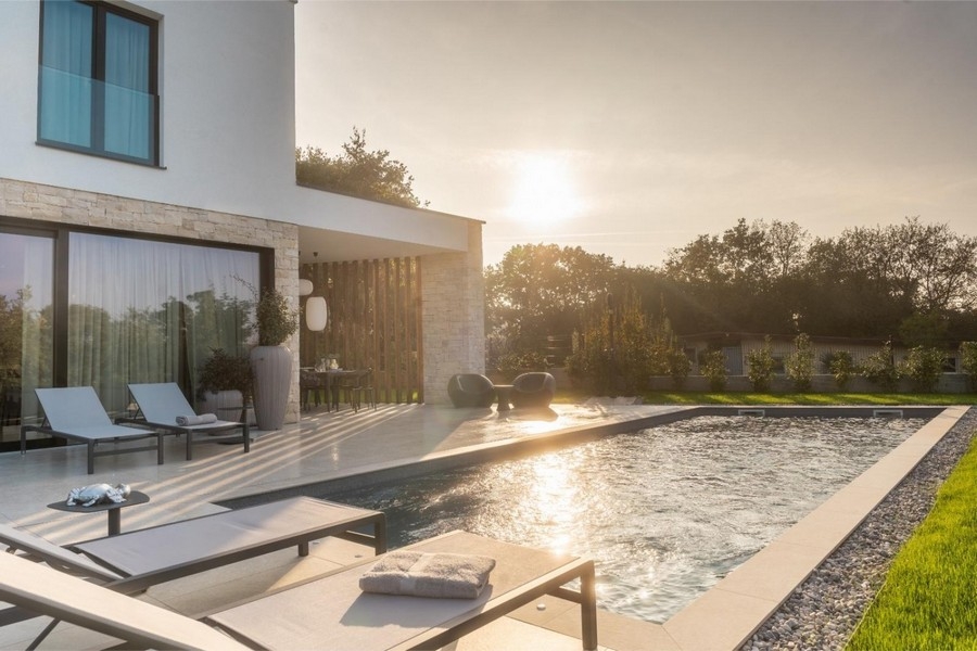 Pool with sunbeds at sunset