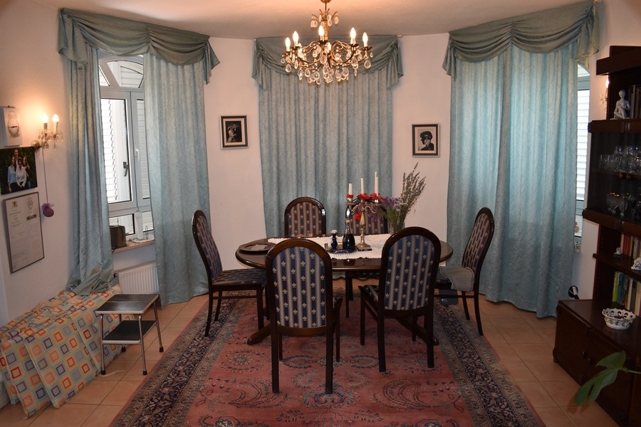 Room with round table and chandelier