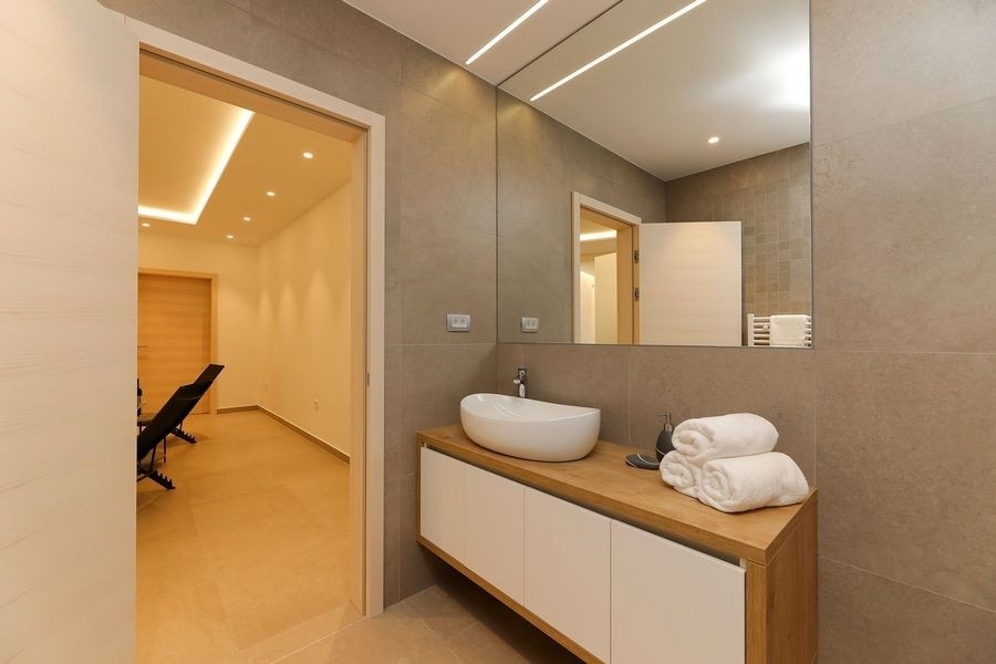 Bathroom with vanity and large mirror