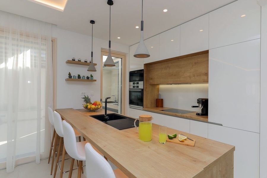 Modern kitchen with breakfast bar and built-in appliances