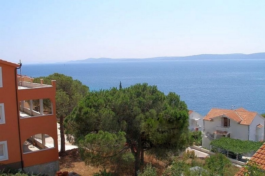 Sea view with pine trees and neighboring houses