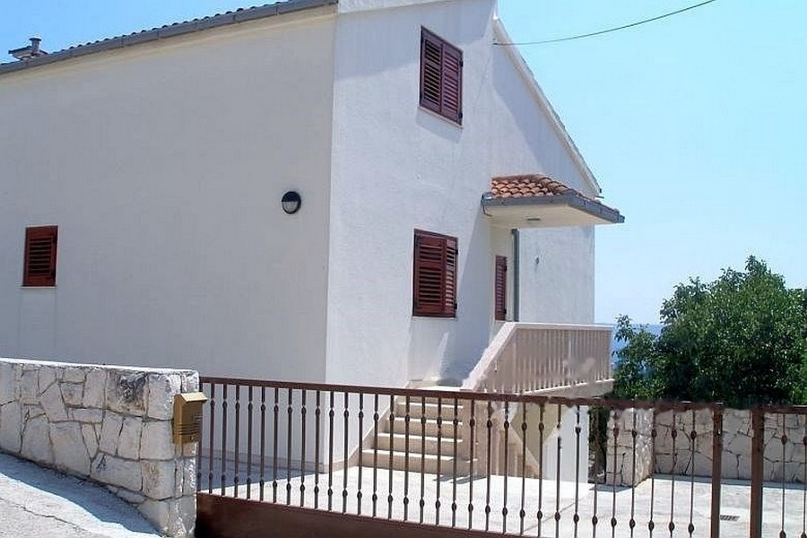 House entrance with stairs and fence