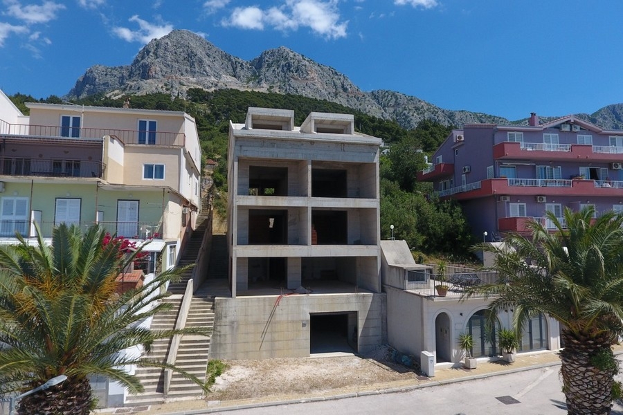 View of unfinished apartment house with Biokovo mountains