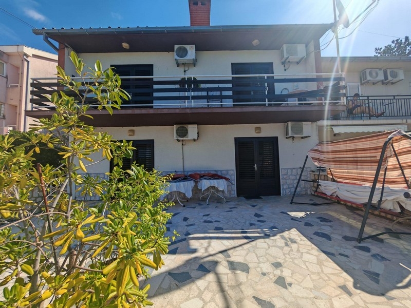 House view with terrace and porch swing