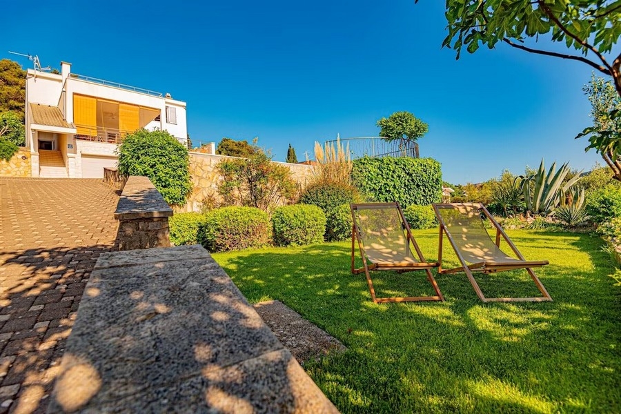 Garden with lawn and deckchairs
