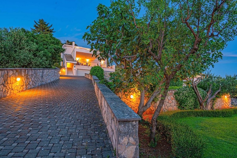 Illuminated paved driveway in the evening
