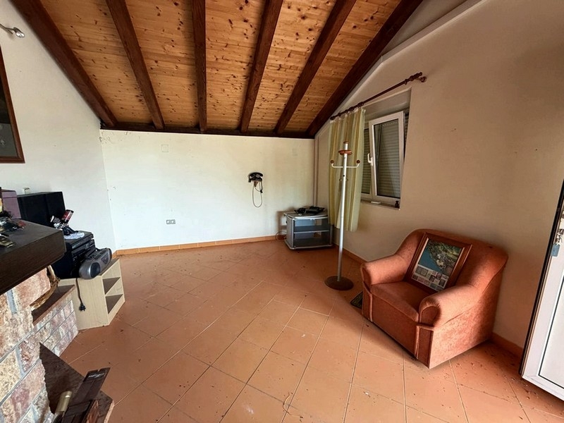 Living room with wooden ceiling and fireplace