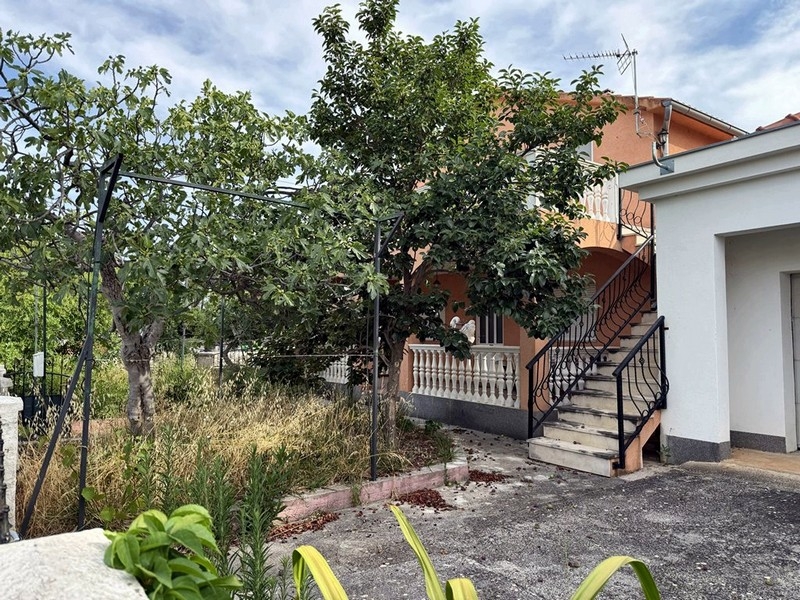 Courtyard with garden and stairs to the upper floor