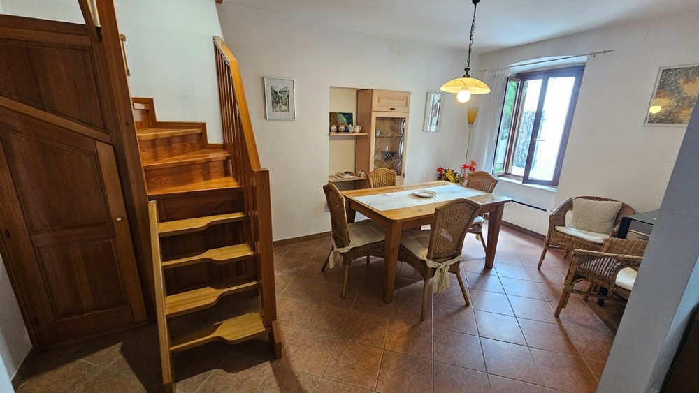 Living area with table and wooden stairs