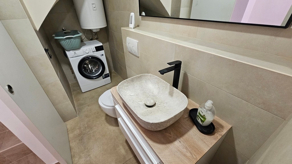 Bathroom with sink and washing machine