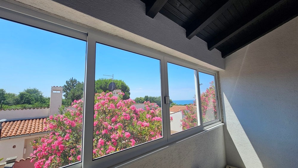 Sea view over the garden through the window