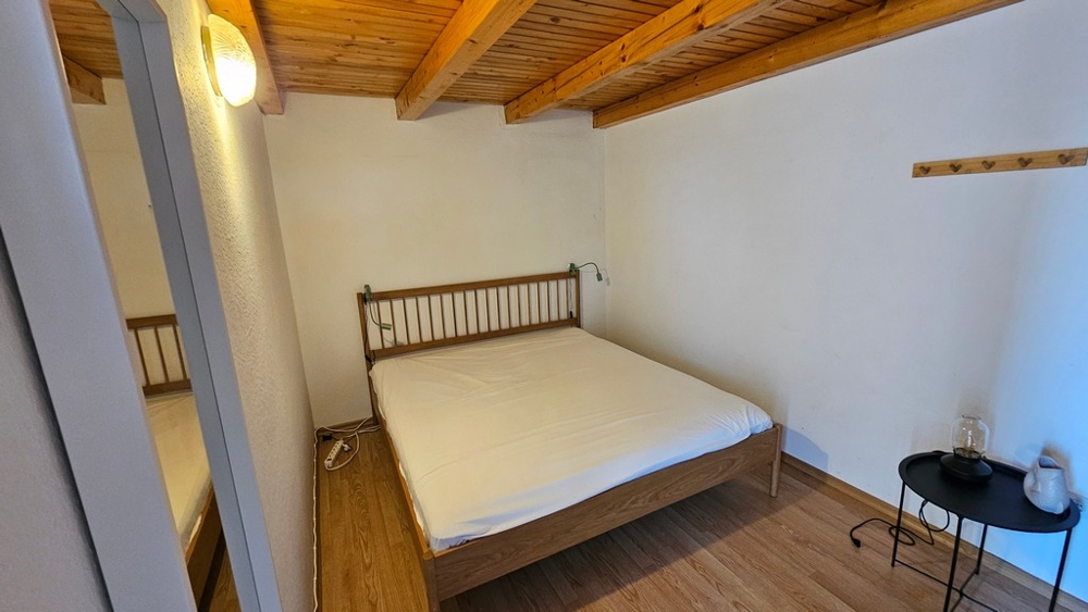 Bedroom with double bed and beamed ceiling