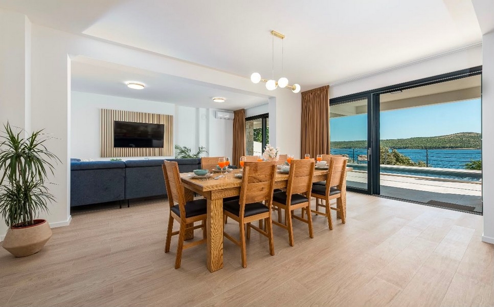 Living room with large table and sea view