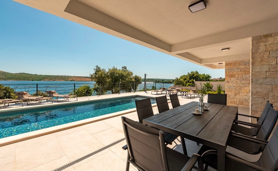 Covered terrace with seating area by the pool