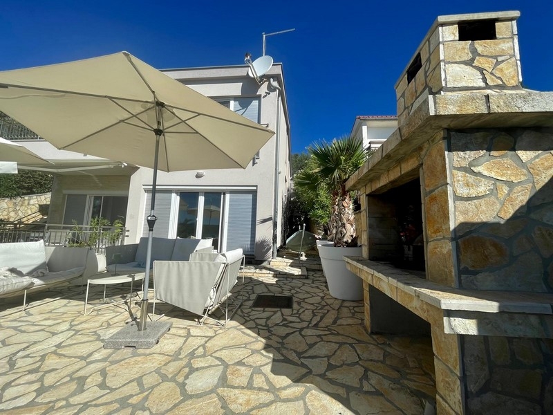 Terrace with masonry stone grill and parasol