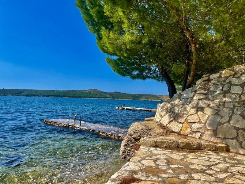 Jetty on the water with natural stone wall in Croatia