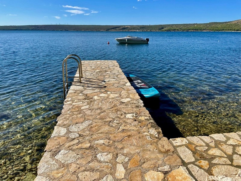 Jetty with bathing ladder at the water
