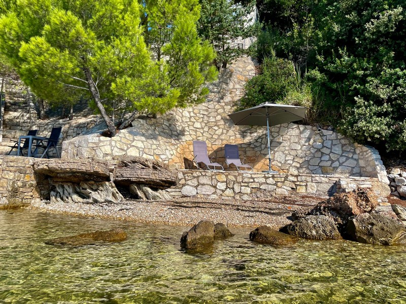 Natural stone terraces on the bank with sunbathing areas