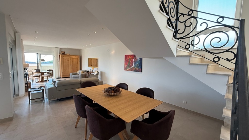 Living and dining area with stairs