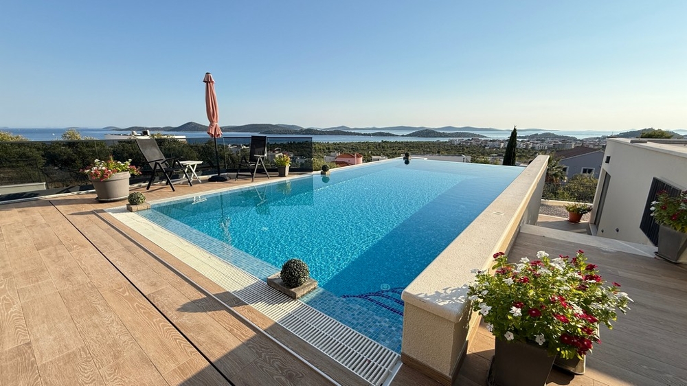 Heated pool with sun terrace and sea views