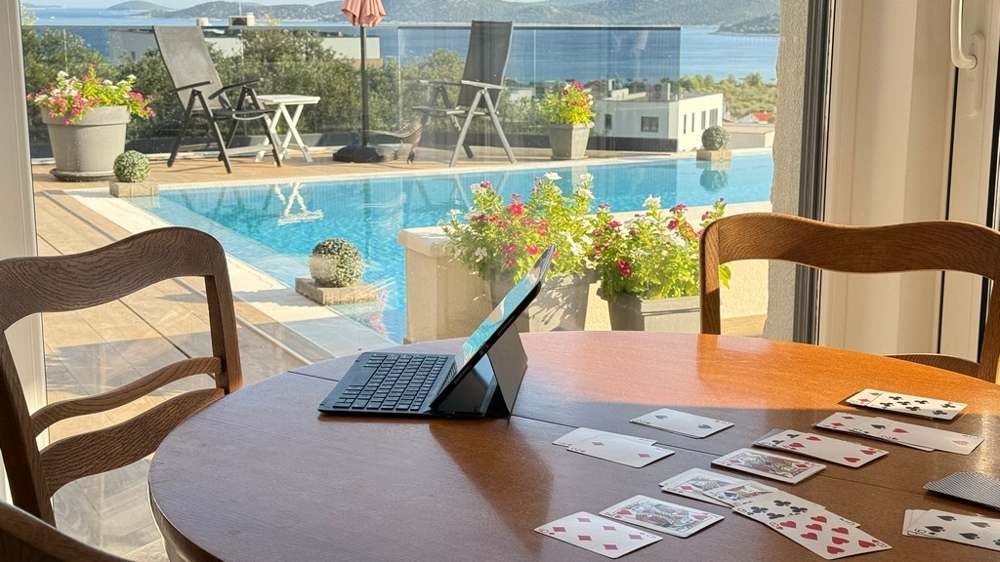 Dining area overlooking pool and sea