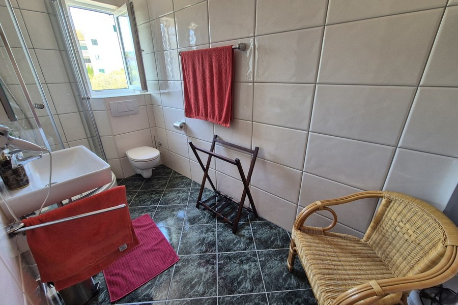 Second bathroom with window and toilet