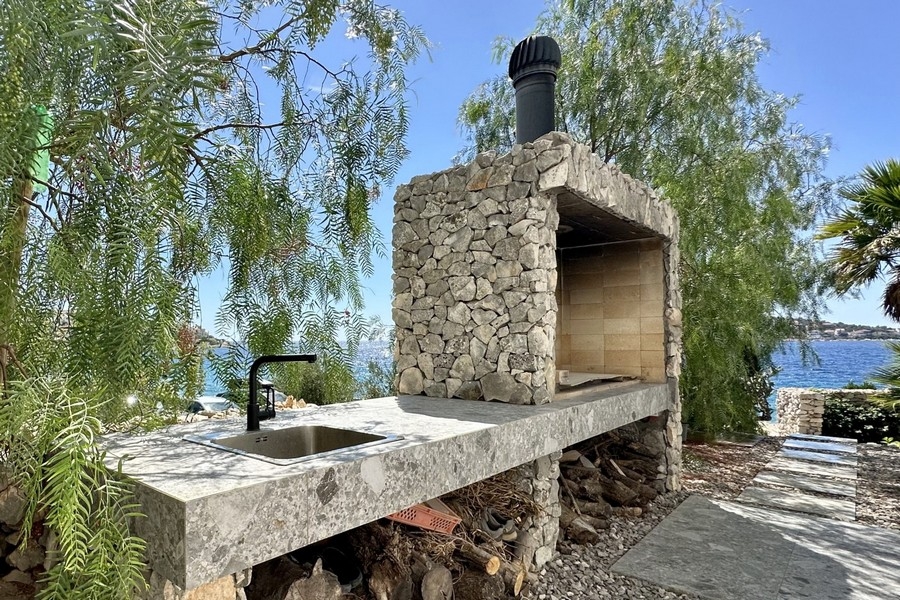 Brick outdoor fireplace with grill and oceanfront sink