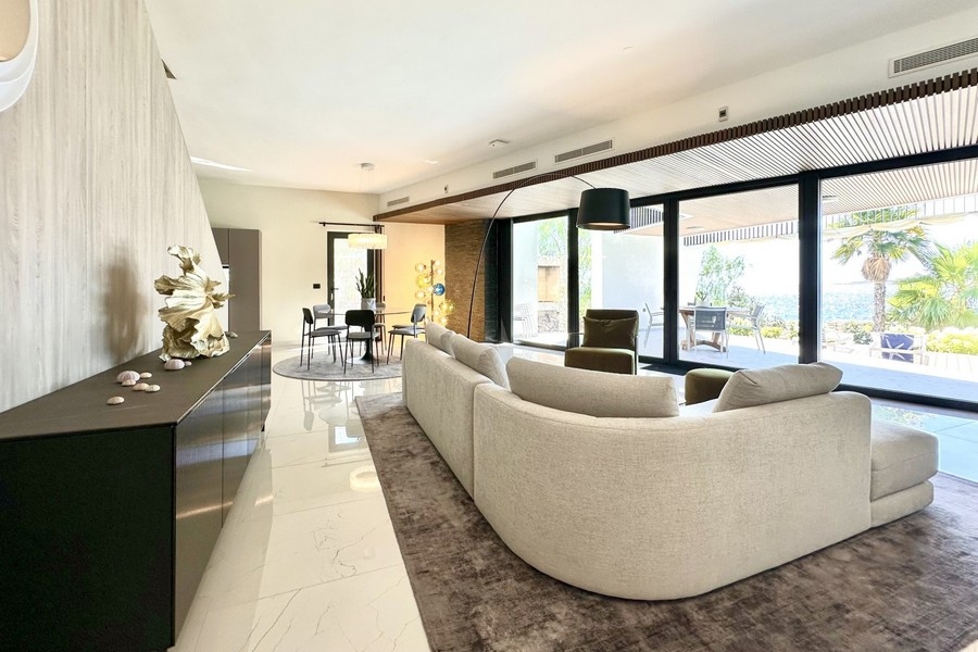 Living area with sofa and large glass fronts