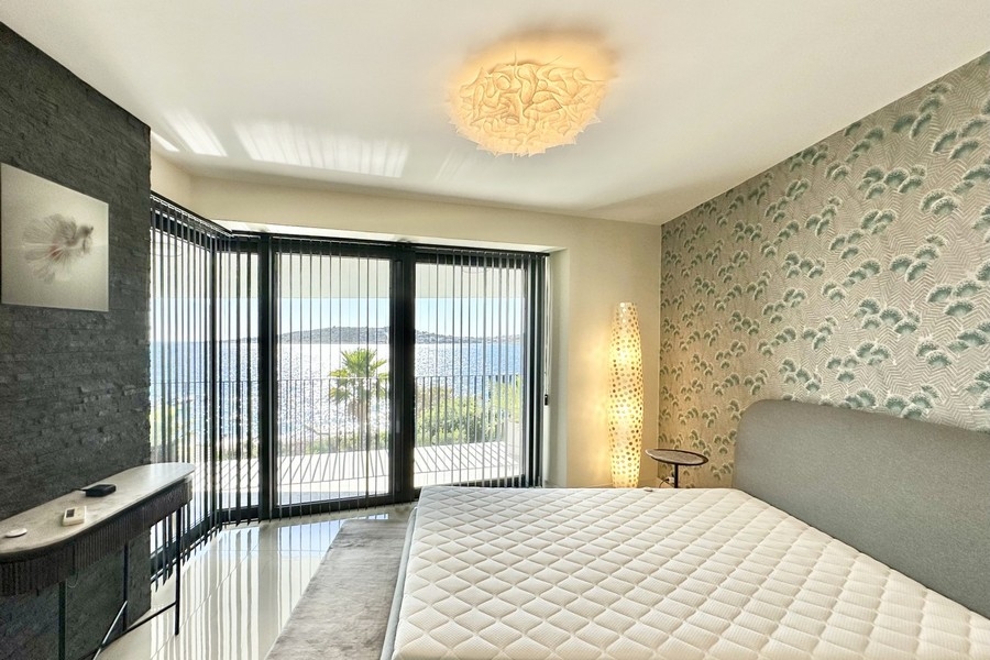 Bedroom with corner glazing and sea views