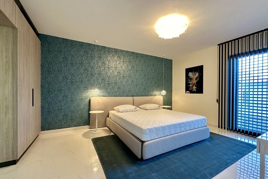 Bedroom with blue accent wall and double bed