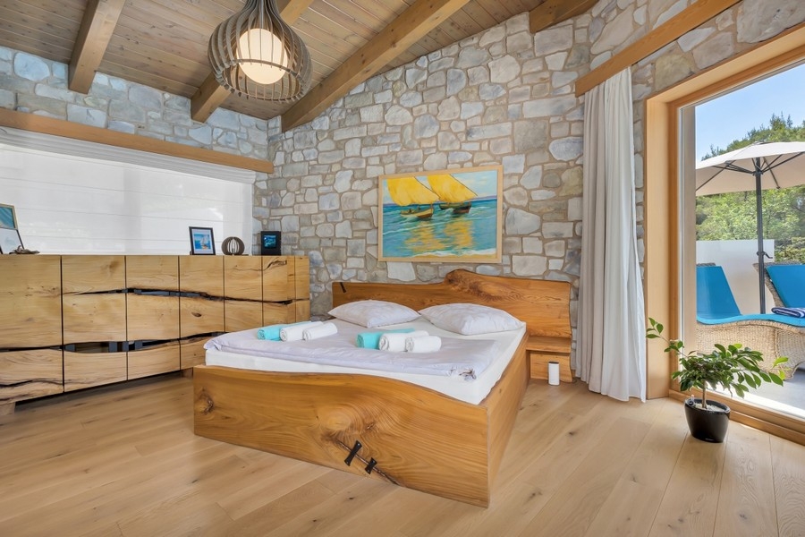 Bedroom with stone wall and pool access