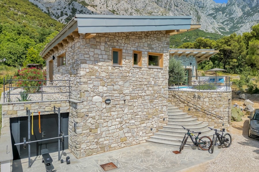 Stone facade with garage and external stairs