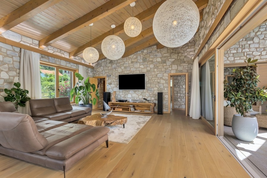 Living room with natural stone wall and TV