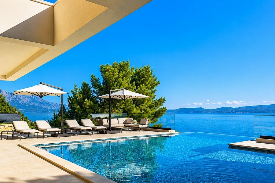 Pool terrace with sun loungers and sea views