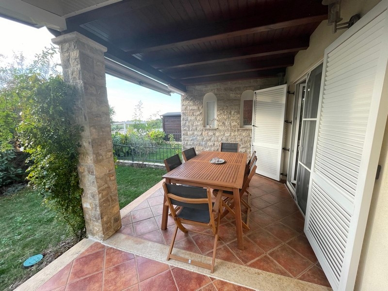 Covered terrace with seating area and garden