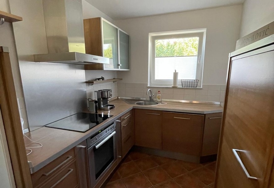 Kitchen with oven and extractor hood