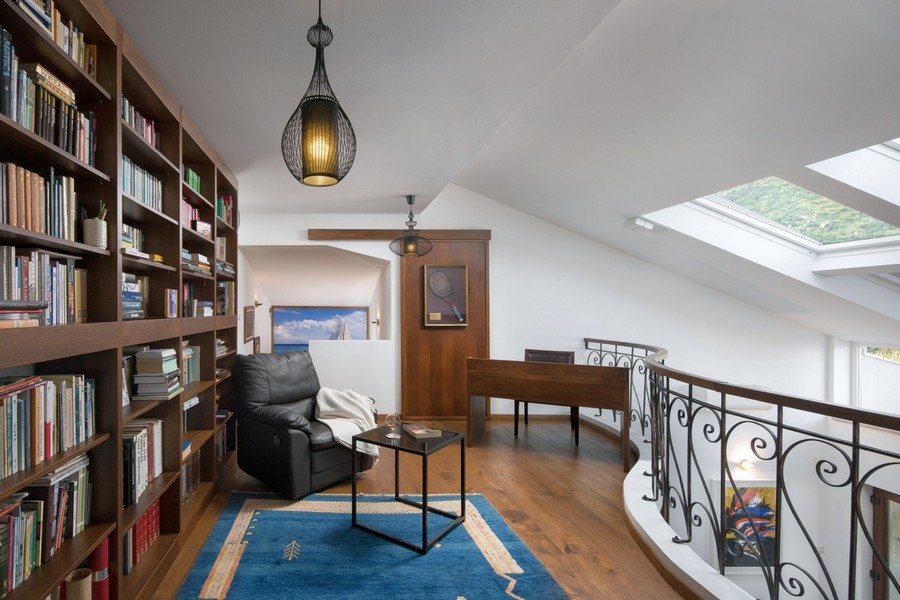 Gallery with reading corner and bookshelf