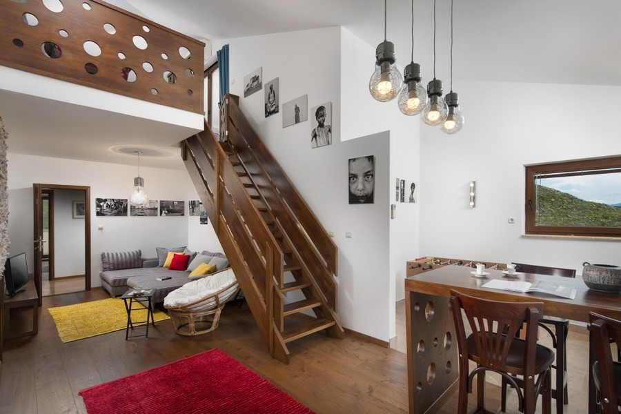 Living area with wooden stairs to the gallery
