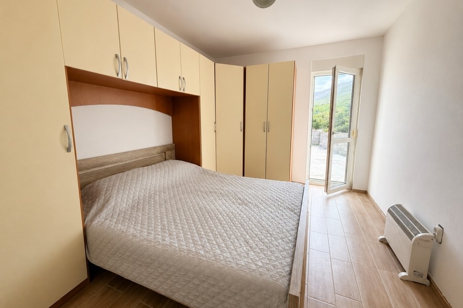 Bedroom with fitted wardrobes and access to the terrace