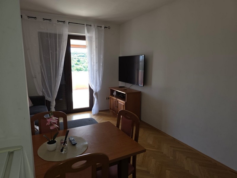 Living room with table, television and patio door