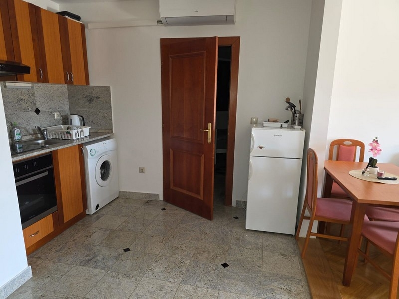 Kitchen with oven, washing machine and refrigerator