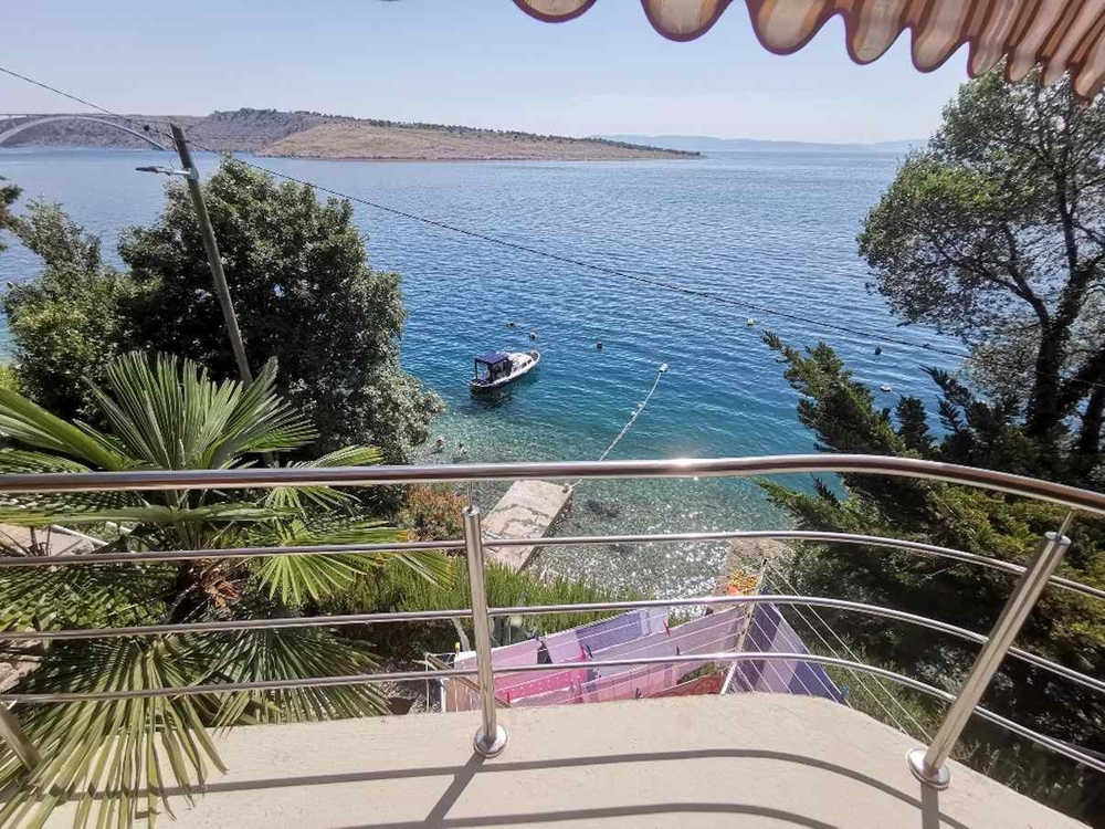 Sea view from balcony with boat in the bay