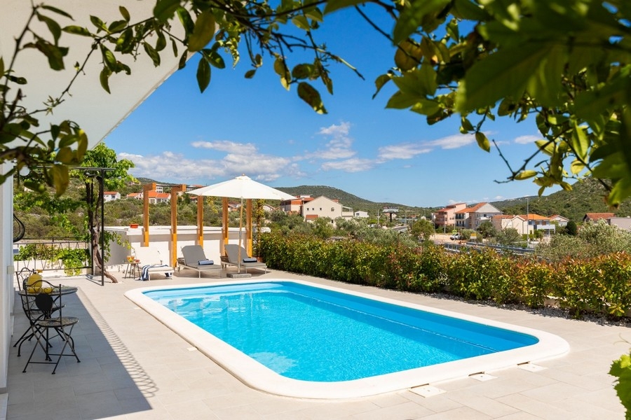 Pool terrace with parasols and loungers