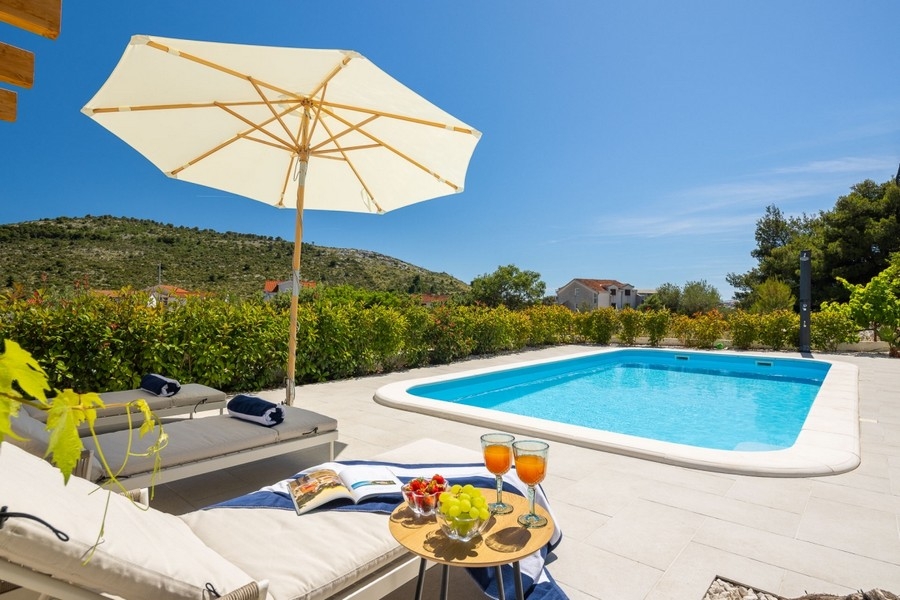 Sun lounger and set table by the pool