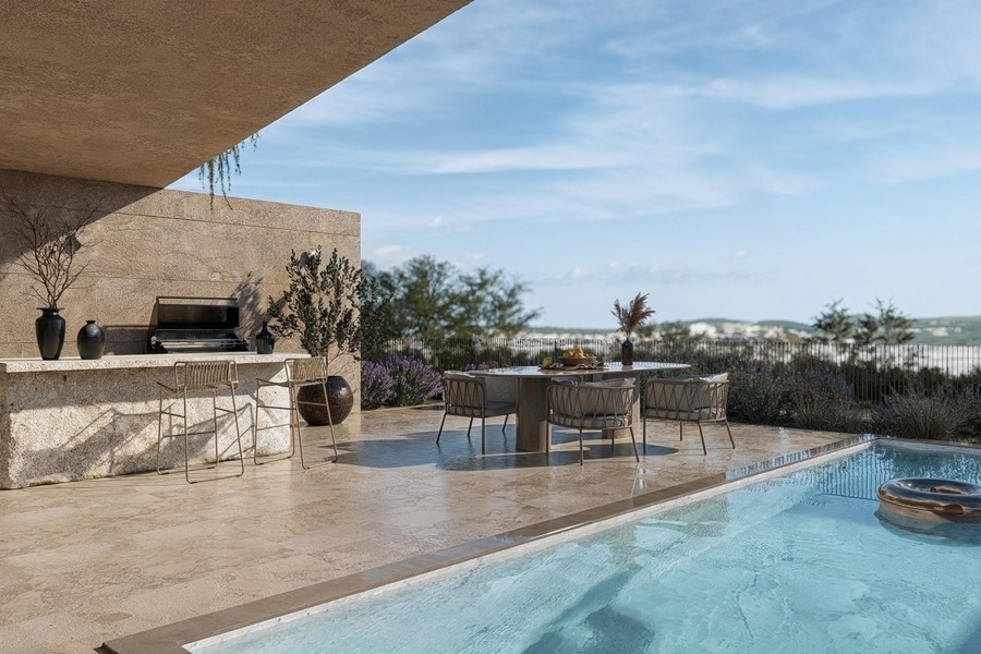 Outdoor kitchen with wet bar next to the swimming pool